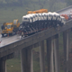 Illustration for article titled Truck Carrying Ten Smaller Trucks Nearly Falls Off Chinese Bridge